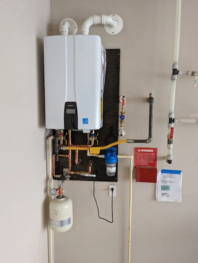 Professional plumber installing copper piping in a Edgewater home